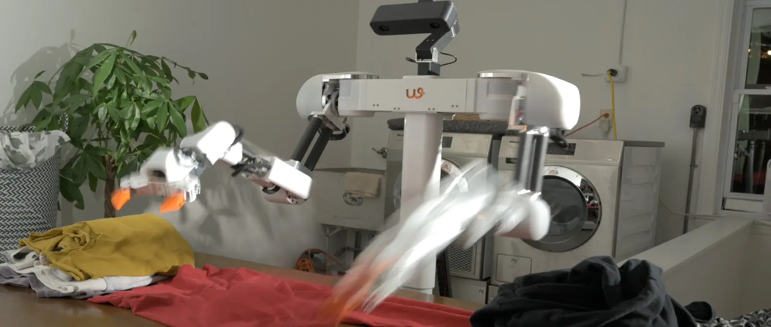 Weave Isaac 0 robot folding laundry in modern home setting, showing the $7,999 automated laundry system in action