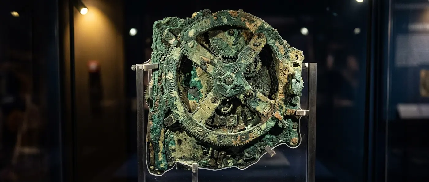 Ancient bronze Antikythera Mechanism showing intricate gear system and astronomical calculations